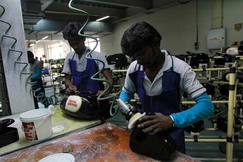 shutterstock_2465787547.jpg Two workers assembling products in a factory environment