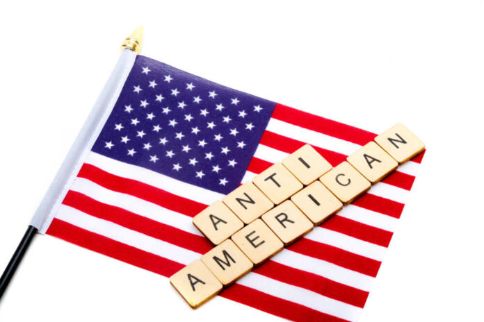 shutterstock_1632758854.jpg American flag with scrabble tiles spelling 'ANTI AMERICAN'
