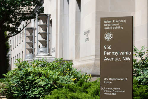 Exterior view of the Robert F. Kennedy Department of Justice Building with a sign