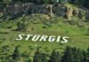 Large white letters spelling 'STURGIS' on a hillside