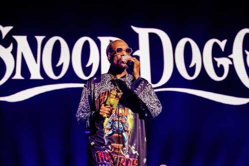 A music artist performing on stage with a microphone