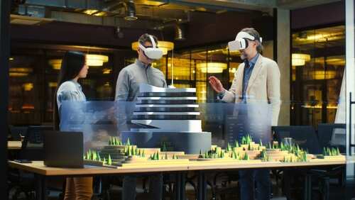 Three individuals using virtual reality headsets to view a 3D architectural model