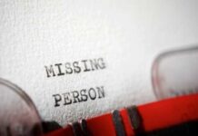 Close-up of a typewriter document with the words 'MISSING PERSON' typed on it