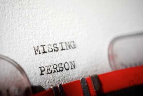 Close-up of a typewriter document with the words 'MISSING PERSON' typed on it