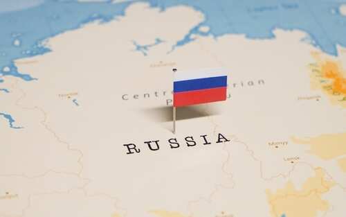 A small Russian flag placed on a map indicating the country Russia