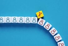 Colorful dice with icons representing people and scissors on a blue background