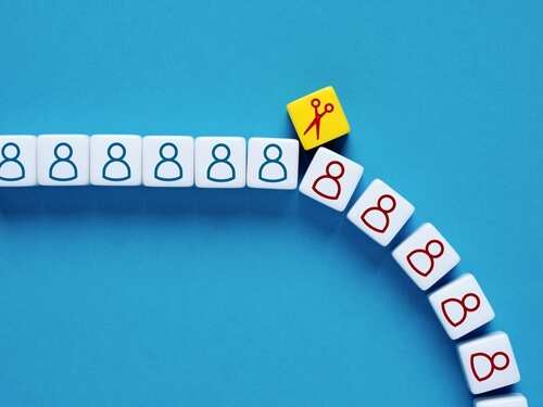 Colorful dice with icons representing people and scissors on a blue background