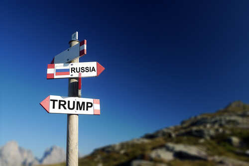 shutterstock_554742967.jpg A directional signpost with arrows pointing to 'RUSSIA' and 'TRUMP' against a clear blue sky