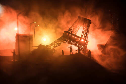 shutterstock_1688204449.jpg Miniature Eiffel Tower surrounded by smoke and dramatic lighting