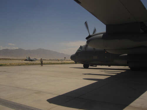 shutterstock_2027238122.jpg Military aircraft on an airfield with a crew member in the foreground
