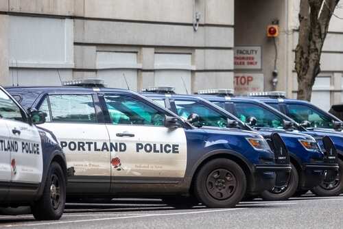 shutterstock_2253226959.jpg Several Portland police cars parked along a city street