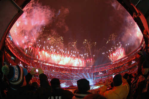 shutterstock_787468417.jpg Fireworks lighting up the sky above a stadium filled with spectators