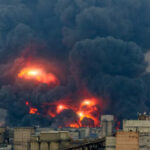 Munitions Plant DISASTER — 14 Dead Large industrial fire with thick black smoke and flames