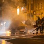 Heroes SAVE Drug-Fueled Driver From FLAMES Firefighters extinguishing a car fire on a city street at night