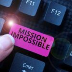 Mission Impossible Style Heist – Brazen act of theft! A finger pressing a pink key labeled 'MISSION IMPOSSIBLE' on a keyboard