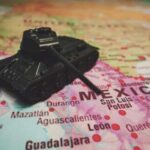 Drug Lords DECLARE WAR on Americans A toy tank placed on a map highlighting Mexico