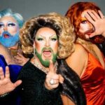 Three drag performers posing dramatically in vibrant costumes and makeup