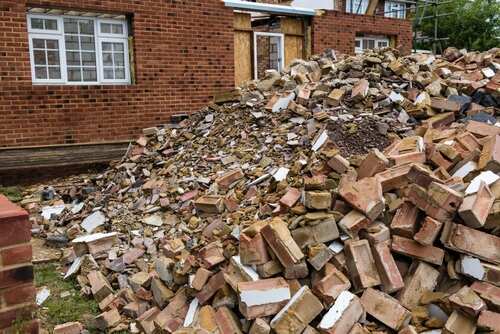 A large pile of bricks and debris at a construction site