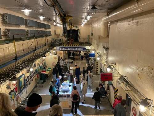 Visitors exploring an underground museum exhibit with industrial decor