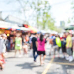 HORROR: Vehicle Plows Into Children’s Celebration Crowd of people at a bustling outdoor market with colorful stalls