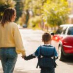 SHOCK: Mother’s Heroic Stand Ends in Tragedy A mother holding hands with her son while walking down a sunny street