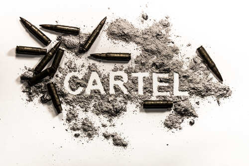 The word 'CARTEL' formed with gunpowder and surrounded by bullet casings