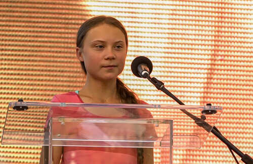 Young activist speaking at a podium with a microphone