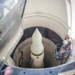 View of a missile inside a silo with maintenance equipment