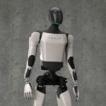 A humanoid robot designed by Tesla standing against a gray background