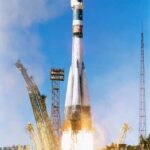 A rocket launching into the sky with smoke and flames