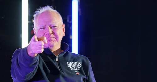 shutterstock_2536081641.jpg A man in a dark sweater pointing directly at the camera with a confident expression