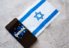 A smartphone displaying the word 'bonds' next to the Israeli flag