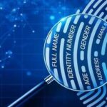 A magnifying glass focusing on a fingerprint with personal information labels