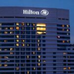 Hilton hotel building illuminated at night