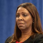 A woman with a serious expression attending a conference