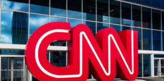 Red CNN logo outside glass building entrance
