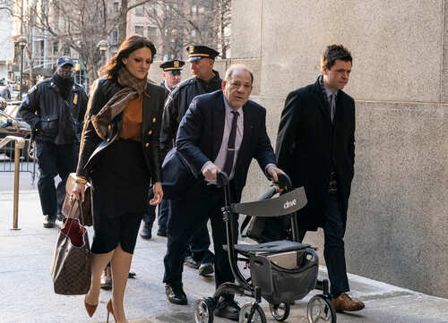 shutterstock_1650026233.jpg Individuals walking outside a courthouse with police presence