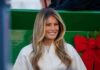 Melania Film Yanked — Amazon’s Power Flex? Smiling woman in festive attire at a public event
