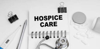 Notebook with 'HOSPICE CARE' written on it, surrounded by medical tools