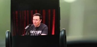 Elon Musk being interviewed on a podcast displayed on a smartphone