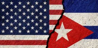 A cracked surface displaying the flags of the United States and Cuba