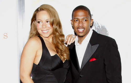 Mariah Carey and Nick Cannon posing together at a red carpet event