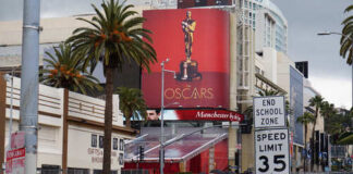 Billboard advertising the Oscars with a golden statue in Hollywood