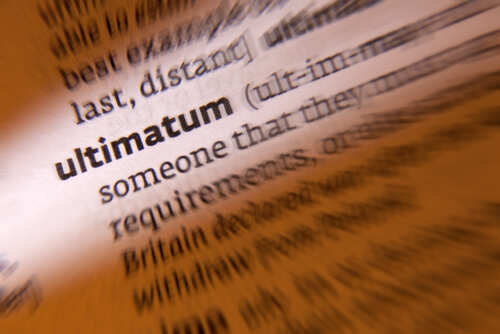 Close-up of a dictionary page highlighting the word 'ultimatum'