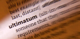 Close-up of a dictionary page highlighting the word 'ultimatum'
