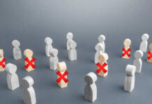 Wooden figures representing people with some marked for exclusion