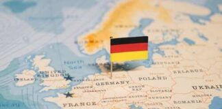 A small German flag placed on a map of Europe highlighting Germany