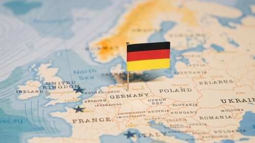 A small German flag placed on a map of Europe highlighting Germany