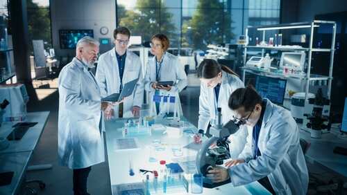 Group of scientists in a laboratory working together on experiments