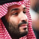 A man wearing traditional Saudi attire with a red and white headdress